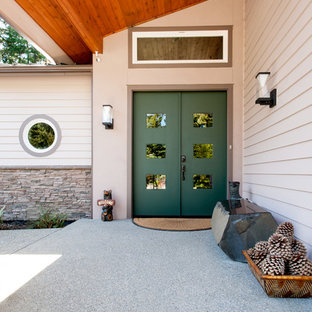 Inspiration for a large eclectic front door in Seattle with beige walls, concrete floors, a double front door and a green front door.