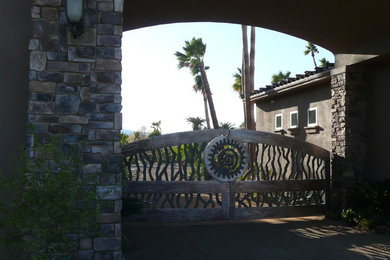 Example of a large mountain style entryway design in Los Angeles with brown walls and a dark wood front door