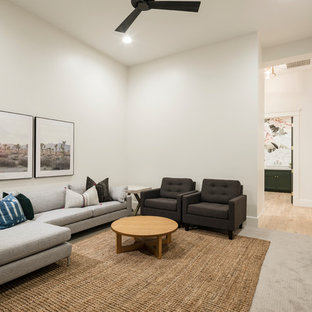 Inspiration for a large traditional open plan home cinema in Phoenix with white walls, carpet, a wall mounted tv and grey floors.