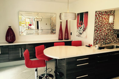 Eat-in kitchen - small contemporary u-shaped porcelain tile eat-in kitchen idea in Miami with stainless steel appliances, a drop-in sink, an island, flat-panel cabinets, white cabinets, marble countertops, white backsplash and porcelain backsplash