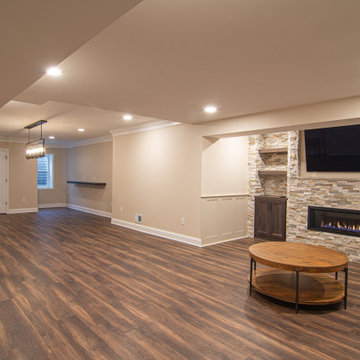 Basement Showing Warm Colors, Straight Lined Cabinets and Stacked Stone