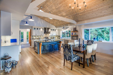 Inspiration for a mid-sized coastal light wood floor and brown floor kitchen/dining room combo remodel in Vancouver with gray walls and no fireplace