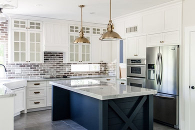 Mid-sized cottage u-shaped ceramic tile and gray floor eat-in kitchen photo in Phoenix with a farmhouse sink, shaker cabinets, white cabinets, quartzite countertops, gray backsplash, brick backsplash, stainless steel appliances, an island and white countertops