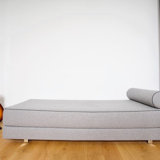 Inspiration for a small modern study in Other with white walls, light hardwood flooring, a freestanding desk and yellow floors.