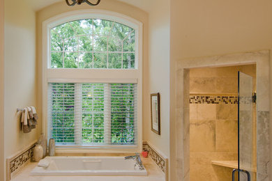 Bathroom - mid-sized traditional master beige tile and stone tile porcelain tile bathroom idea in Other with medium tone wood cabinets, marble countertops, beige walls, raised-panel cabinets, a two-piece toilet and an undermount sink