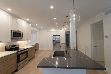 Example of a minimalist kitchen design in Miami with an island