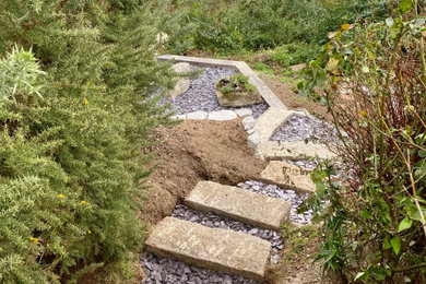 This is an example of a medium sized rustic sloped garden in Cornwall.