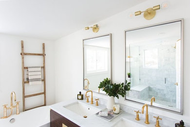 Midcentury master bathroom in Salt Lake City with a freestanding tub and white walls.