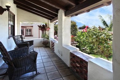 Inspiration for a mid-sized mediterranean balcony in Orange County with a roof extension.