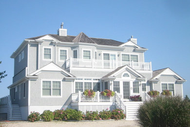 Design ideas for a large beach style two-storey blue exterior in New York.