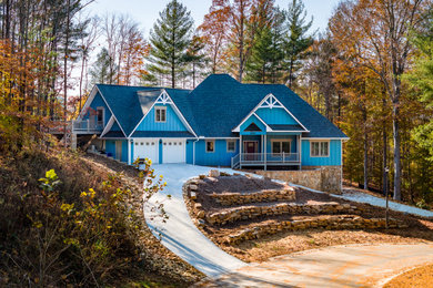Inspiration for a large craftsman blue two-story concrete fiberboard and board and batten exterior home remodel in Charlotte with a shingle roof and a gray roof
