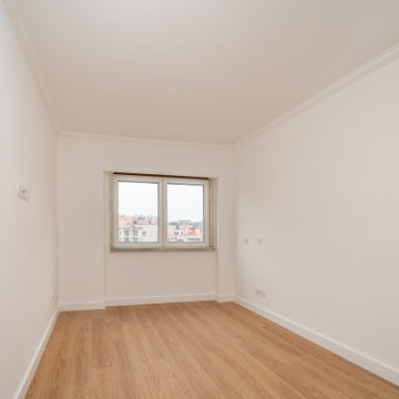 Bedroom Window Corner with White Walls and Wood Floor