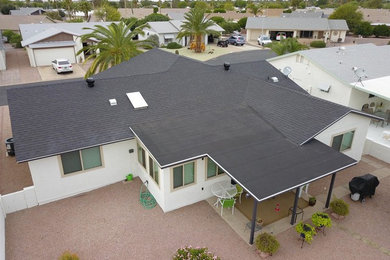 Example of a mid-sized trendy white one-story exterior home design in Phoenix with a shingle roof