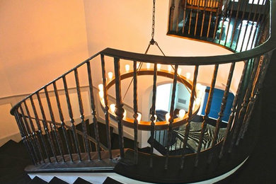 Inspiration for a mid-sized transitional painted curved metal railing staircase remodel in Austin with painted risers