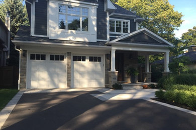 Large traditional blue two-story wood gable roof idea in Toronto