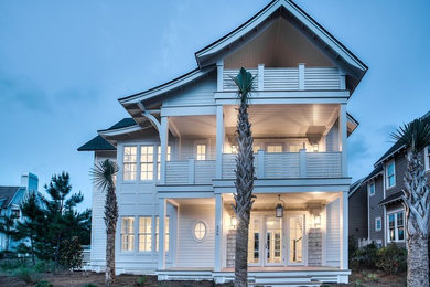 Mid-sized beach style white three-story wood gable roof photo in Miami