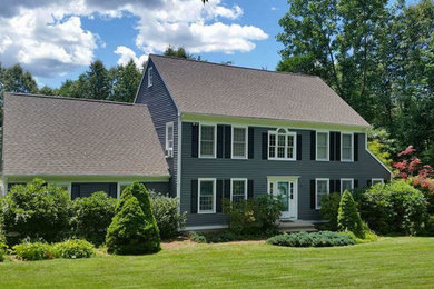 Mid-sized elegant blue two-story wood gable roof photo in New York