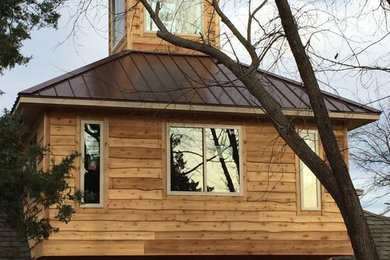 Inspiration for a mid-sized timeless brown two-story mixed siding house exterior remodel in Oklahoma City with a hip roof and a metal roof