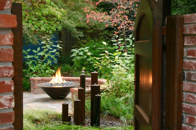 This is an example of a traditional backyard patio in Sacramento with a fire feature and natural stone pavers.