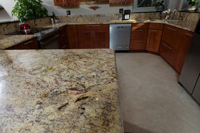 Large u-shaped ceramic tile eat-in kitchen photo in Other with an undermount sink, shaker cabinets, medium tone wood cabinets, granite countertops, stone slab backsplash and stainless steel appliances