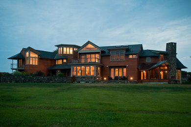 Example of a huge trendy two-story wood exterior home design in Providence