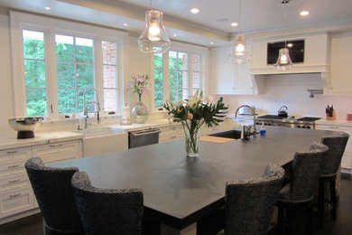Large minimalist l-shaped dark wood floor enclosed kitchen photo in Philadelphia with an integrated sink, stainless steel appliances and an island