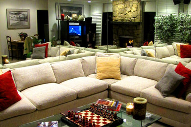 Example of a large minimalist enclosed carpeted living room design with white walls, a standard fireplace, a stone fireplace and a media wall