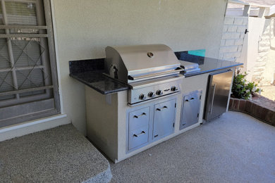 Example of a classic backyard patio kitchen design in Los Angeles