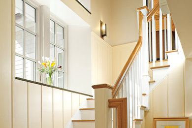 Photo of a mid-sized traditional wood l-shaped staircase in New York with painted wood risers.