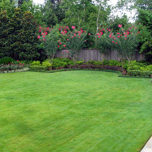 This is an example of a mediterranean backyard garden in Houston with with lawn edging.