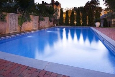 Inspiration for a backyard pool fountain remodel in Raleigh