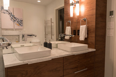 Mid-sized scandinavian master bathroom in Seattle with flat-panel cabinets, dark wood cabinets, a drop-in tub, an open shower, a bidet, gray tile, stone tile, grey walls, marble floors, a vessel sink and marble benchtops.