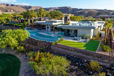 Photo of a large contemporary one-storey white house exterior in Las Vegas with a flat roof.