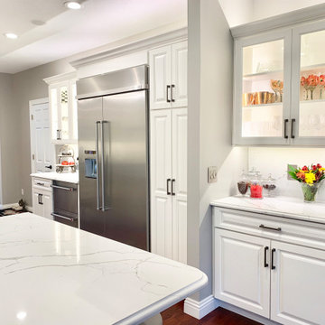 Ivory White Kitchen With Marble Look Quartz Counters and Splash