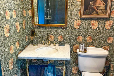 Corner shower - small victorian master green tile and ceramic tile orange floor, single-sink and wallpaper corner shower idea in New York with a one-piece toilet, quartz countertops, a hinged shower door, white countertops and a freestanding vanity