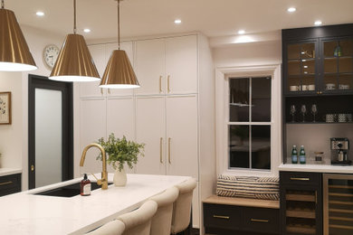 Inspiration for a large contemporary u-shaped medium tone wood floor and beige floor eat-in kitchen remodel in Toronto with an undermount sink, recessed-panel cabinets, dark wood cabinets, quartzite countertops, multicolored backsplash, marble backsplash, stainless steel appliances, two islands and white countertops