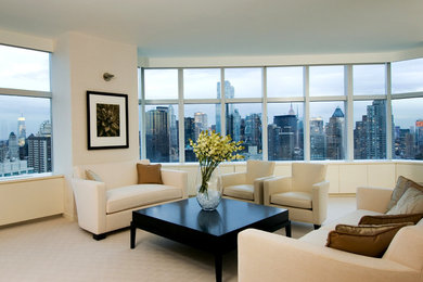 Large modern formal open concept living room in New York with beige walls, carpet, no fireplace and a concealed tv.