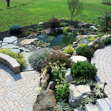 Multiple areas of enjoyment with fire pit, pond and differing patio levels