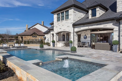 Hot tub - large traditional backyard custom-shaped aboveground hot tub idea in Dallas