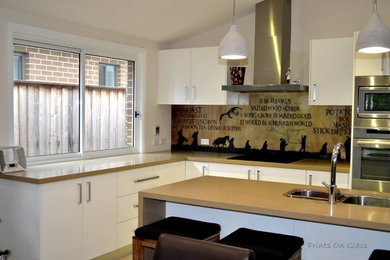 Photo of a kitchen in Sydney with glass sheet splashback.