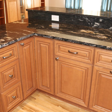 Cinnamon maple glazed cabinets with black granite countertop
