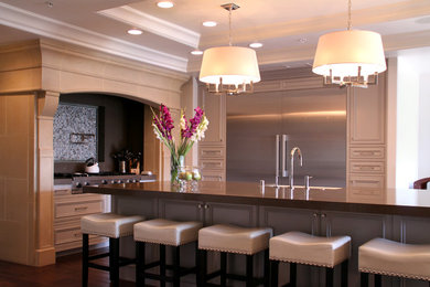 Example of a large transitional dark wood floor open concept kitchen design in Los Angeles with a farmhouse sink, recessed-panel cabinets, gray cabinets, quartz countertops, stainless steel appliances and an island