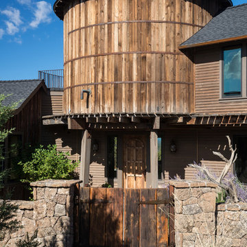 Water tower inspired home front elevation close up of gate & tower