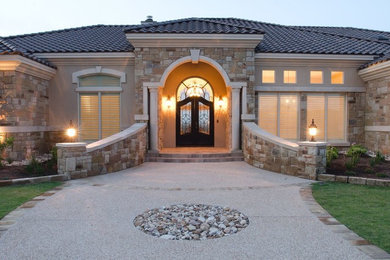 Large traditional beige one-story mixed siding exterior home idea in Austin with a hip roof