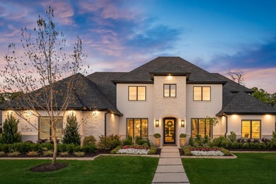 Inspiration for a transitional beige two-story house exterior remodel in Dallas with a hip roof, a shingle roof and a gray roof