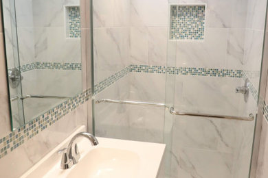 Example of a small transitional 3/4 white tile and porcelain tile porcelain tile, white floor and single-sink bathroom design in New York with white cabinets, a two-piece toilet, white walls, an integrated sink and a niche