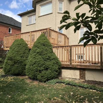 Two-level pressure-treated deck with wood railings on a Markham home, seen from