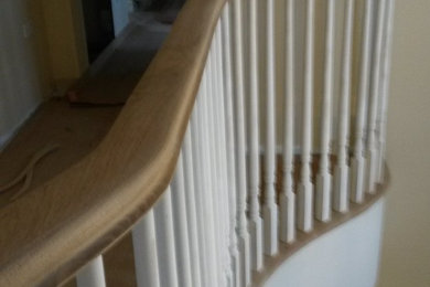 Oak and paint staircase with continuous handrail.
