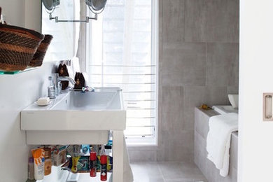 Inspiration for a mid-sized transitional master gray tile and porcelain tile porcelain tile and gray floor bathroom remodel in Chicago with furniture-like cabinets, white cabinets, a one-piece toilet, white walls, an integrated sink and solid surface countertops