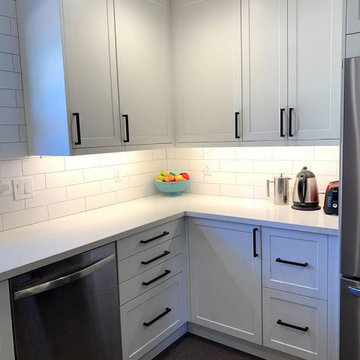 ikea white cabinets with subway tile backsplash and floating shelves